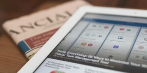 Φωτογραφία που απεικονίζει ένα tablet και μια εφημερίδα με ειδήσεις